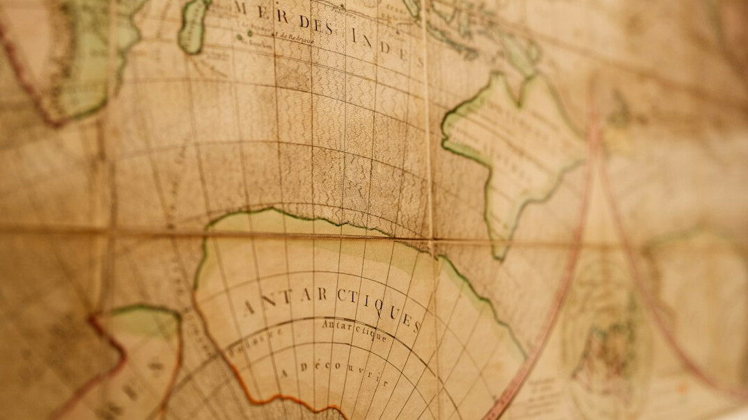 Magnifying glass resting on an old map