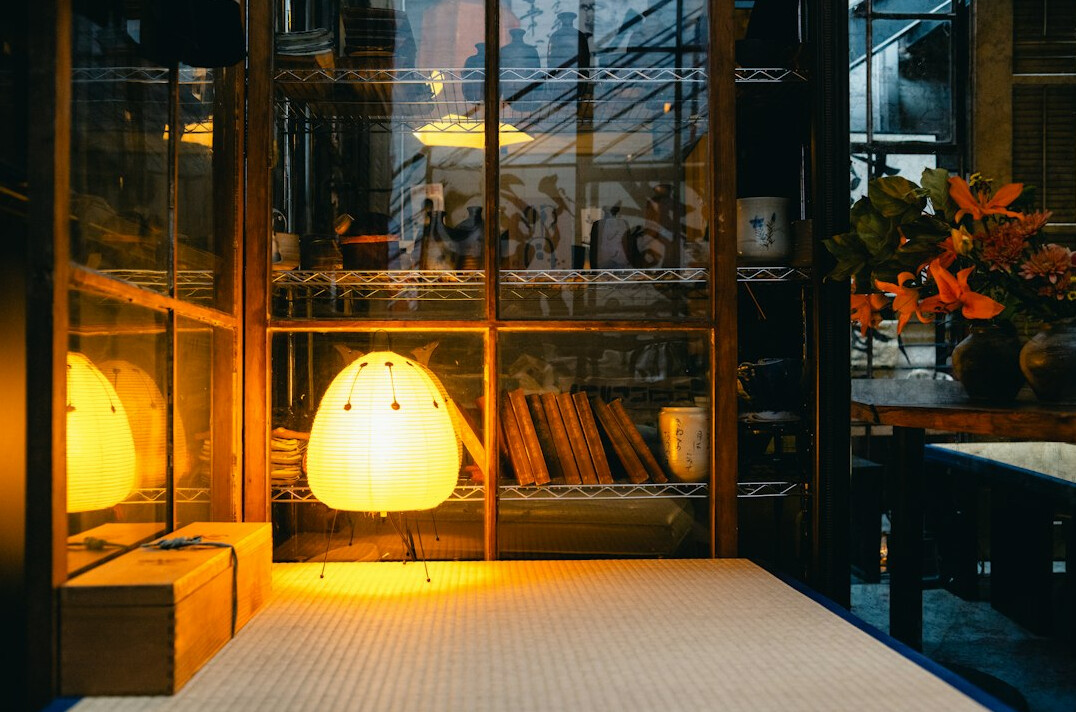Cozy reading nook with books and warm lamp light