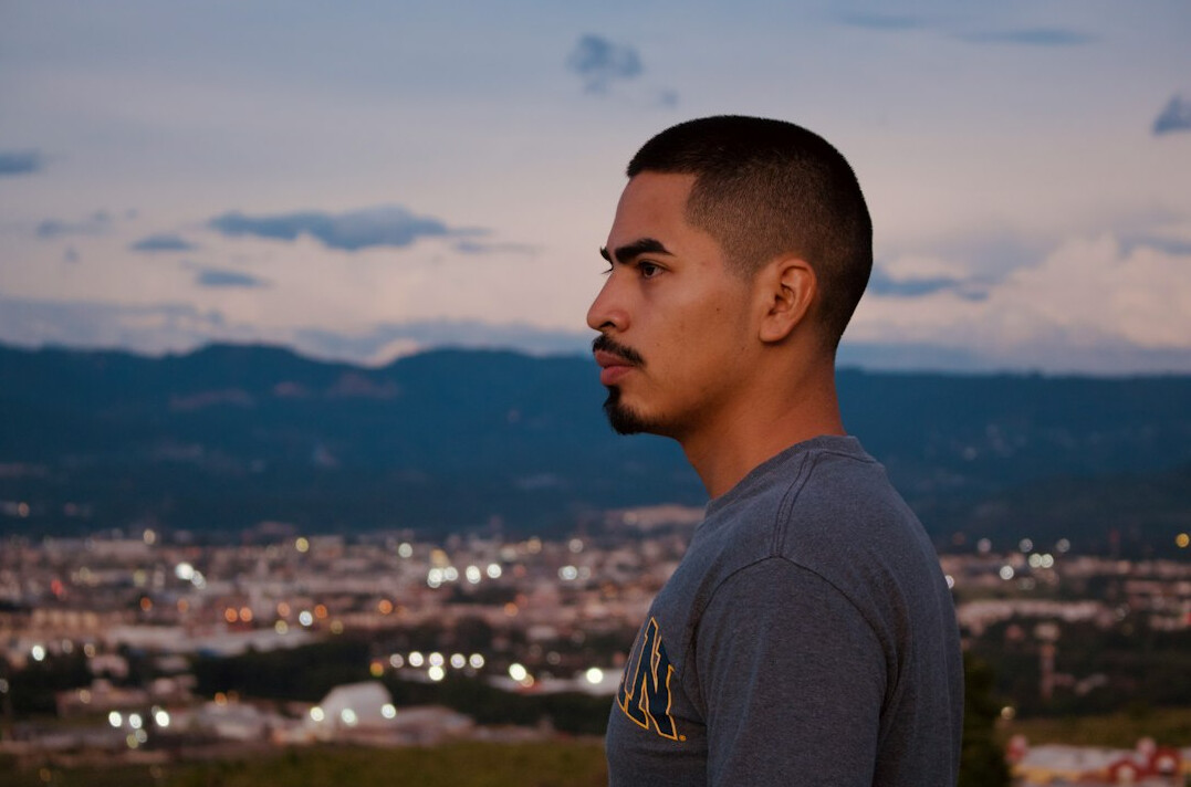 Studio portrait of a Latin American man in his thirties, fiction editor