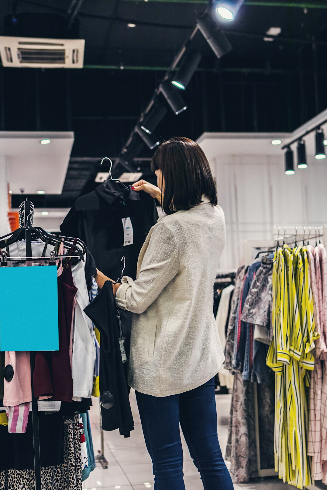 woman trying on coat in store